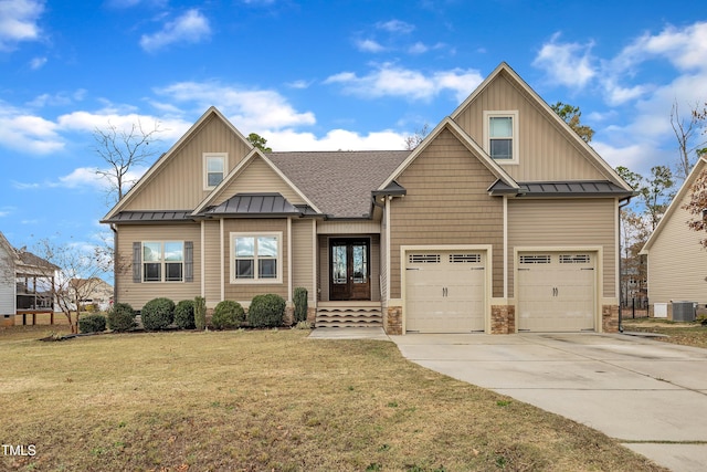 craftsman house with a garage, a front lawn, and cooling unit