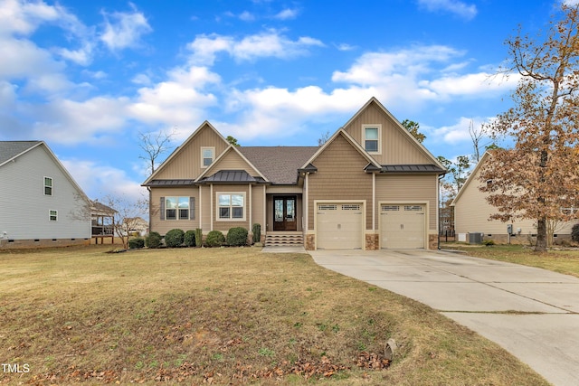 craftsman-style house featuring cooling unit, a garage, and a front lawn