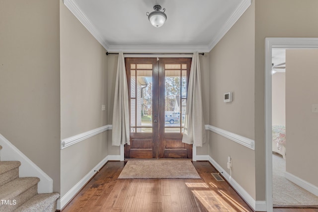 foyer featuring french doors, ceiling fan, crown molding, and hardwood / wood-style floors