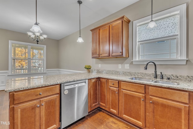 kitchen with dishwasher, sink, a notable chandelier, light hardwood / wood-style floors, and decorative light fixtures