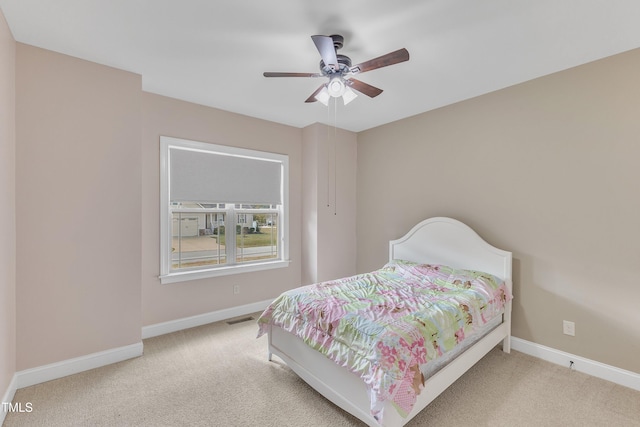 bedroom featuring ceiling fan and light carpet