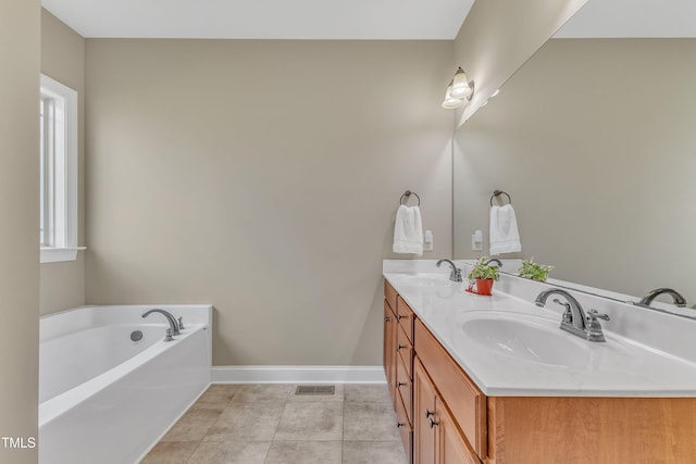 bathroom with vanity, tile patterned floors, and a tub