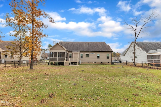 back of property with a yard and a sunroom