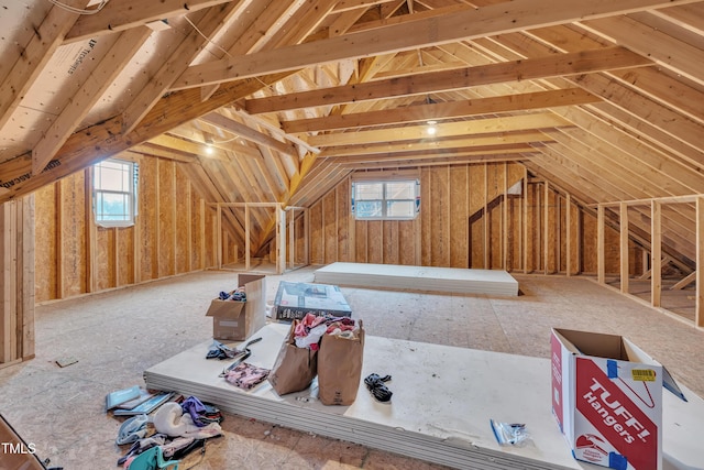 unfinished attic featuring plenty of natural light