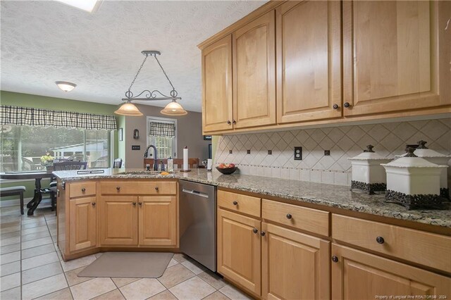 kitchen with dishwasher, decorative backsplash, decorative light fixtures, and dark stone counters