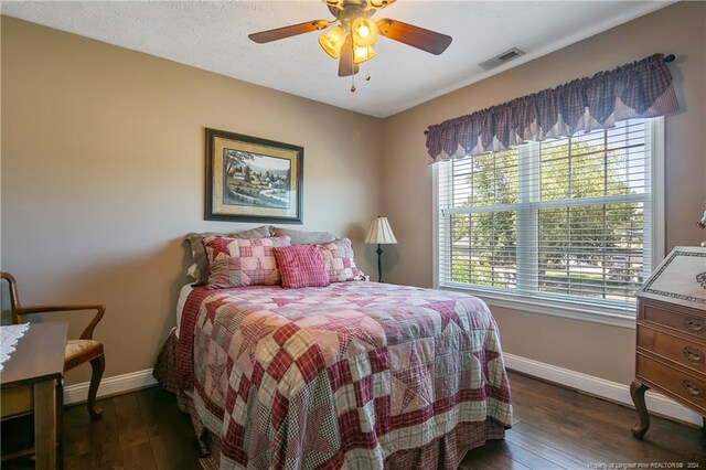 bedroom featuring ceiling fan and dark wood-type flooring