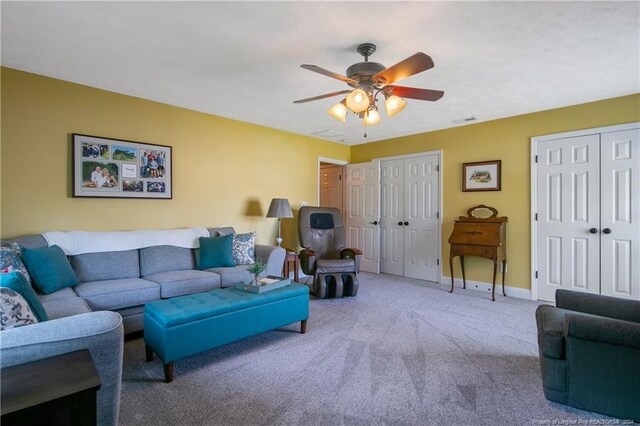 living room featuring carpet flooring and ceiling fan