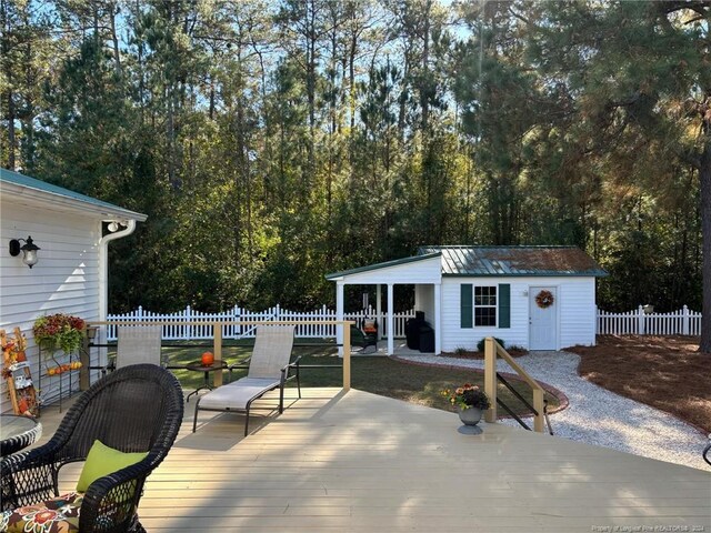 wooden deck featuring an outbuilding