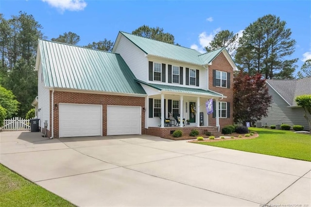view of front facade with driveway, covered porch, brick siding, a front lawn, and a garage