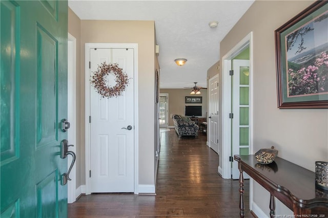 entrance foyer featuring ceiling fan, baseboards, a textured ceiling, french doors, and dark wood-type flooring