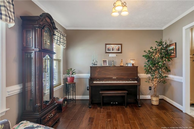 living area with baseboards, wood finished floors, and crown molding