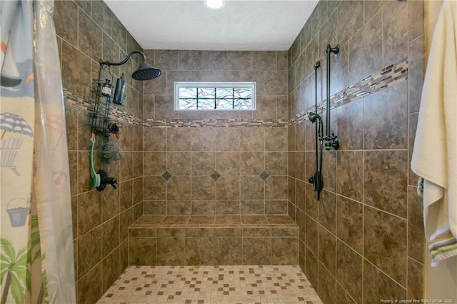 bathroom featuring tiled shower and a textured ceiling