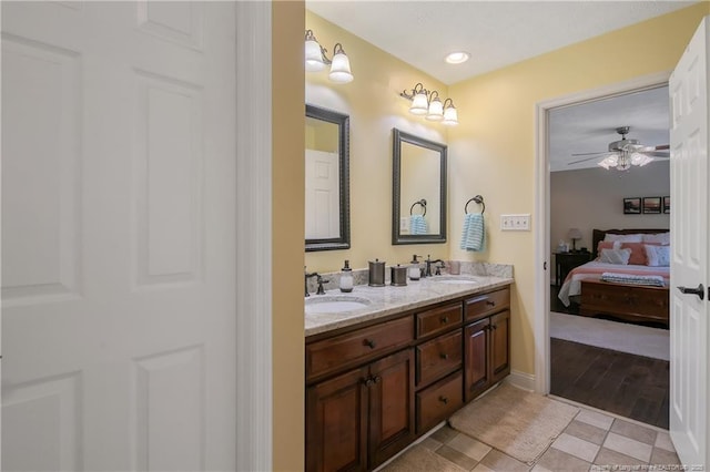 bathroom featuring tile patterned floors, double vanity, a sink, and connected bathroom