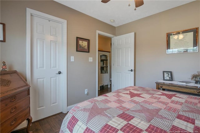 bedroom with a ceiling fan and dark wood finished floors