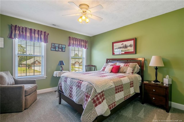 carpeted bedroom featuring a ceiling fan, visible vents, and baseboards