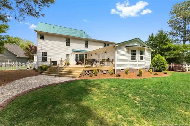 back of property featuring a wooden deck, metal roof, a lawn, crawl space, and fence