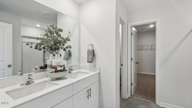 6433 Alfalfa Ln, Wake Forest, NC 27587 - bathroom featuring double vanity, a spacious closet, recessed lighting, and baseboards