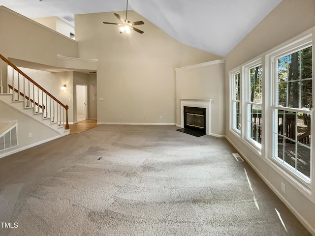 unfurnished living room with carpet, high vaulted ceiling, and ceiling fan