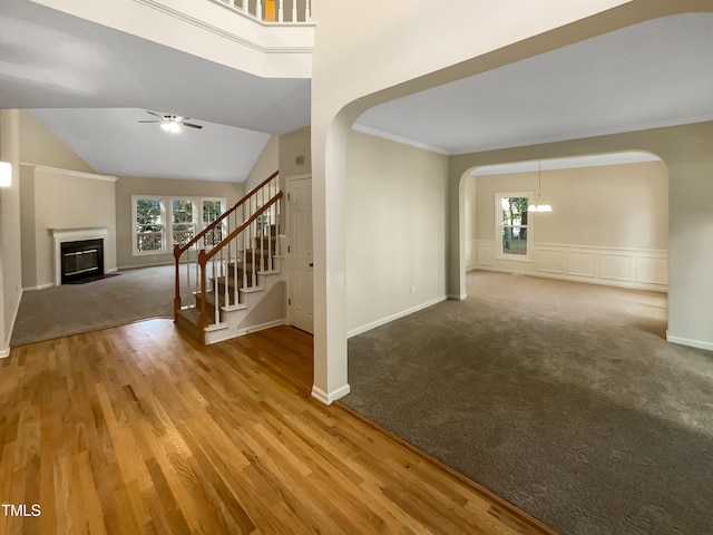 interior space with hardwood / wood-style flooring, vaulted ceiling, ceiling fan, and crown molding