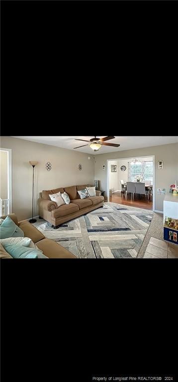 unfurnished living room featuring ceiling fan