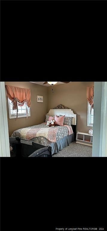 carpeted bedroom with ceiling fan