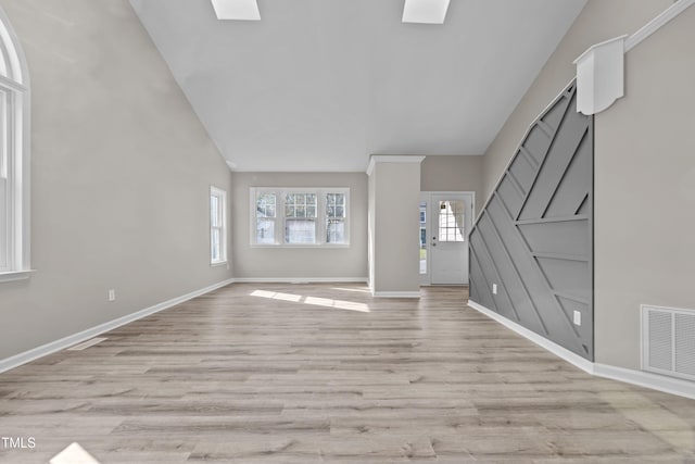 unfurnished living room featuring light hardwood / wood-style floors and high vaulted ceiling