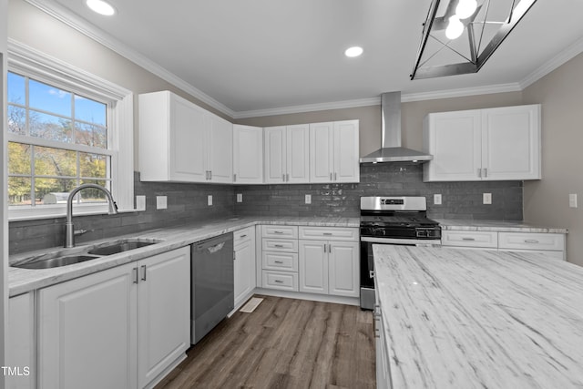 kitchen featuring white cabinetry, wall chimney range hood, dark hardwood / wood-style flooring, appliances with stainless steel finishes, and ornamental molding