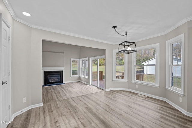 unfurnished living room featuring plenty of natural light and light hardwood / wood-style flooring