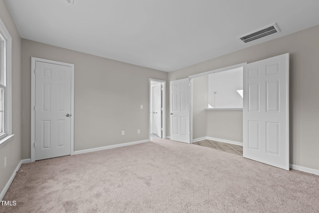 unfurnished bedroom featuring light colored carpet