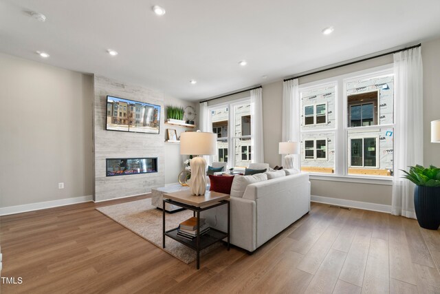 living room with a fireplace and light hardwood / wood-style floors