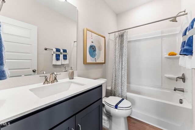 full bathroom featuring hardwood / wood-style flooring, vanity, toilet, and shower / bath combo