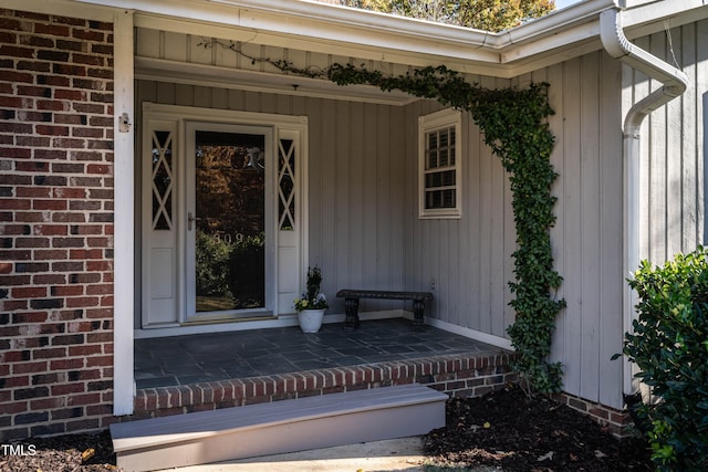 view of exterior entry with covered porch