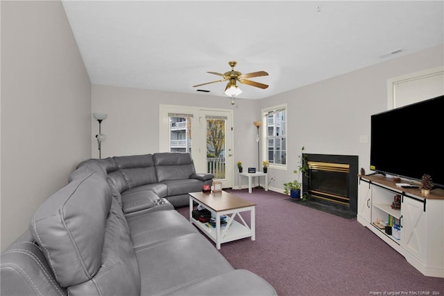 carpeted living room featuring ceiling fan