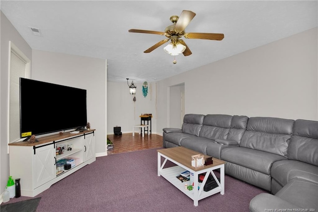 living room with ceiling fan and carpet floors