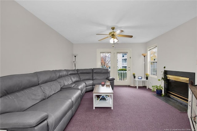 carpeted living room featuring ceiling fan