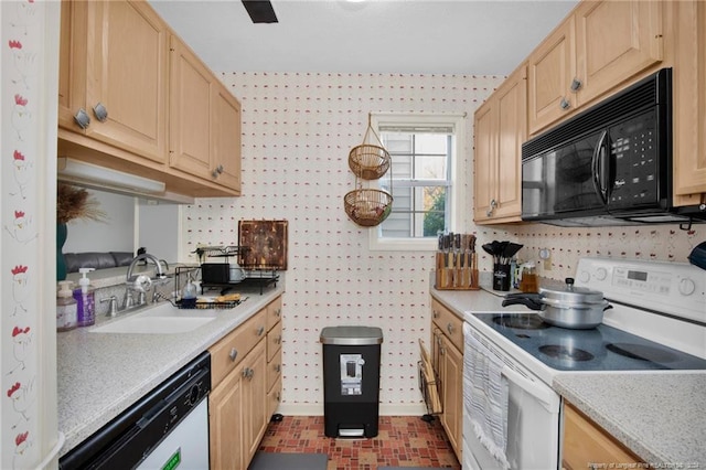 kitchen with light brown cabinetry, sink, and white appliances