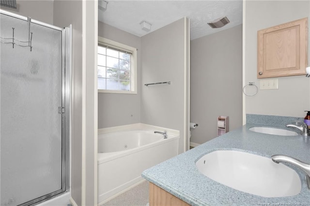 bathroom with vanity, a textured ceiling, and plus walk in shower