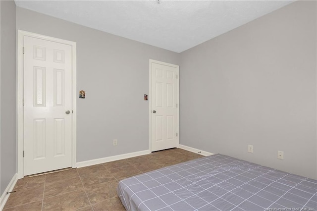 unfurnished bedroom with tile patterned flooring