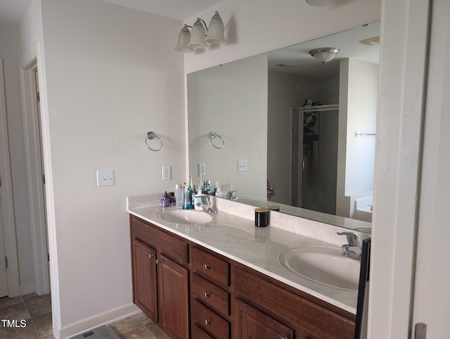 bathroom with tile patterned flooring, vanity, and a shower with shower door