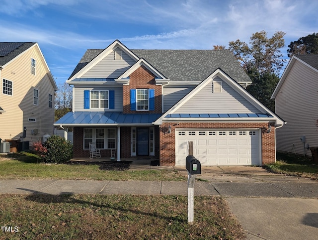 view of front of home with covered porch, central AC, and a garage