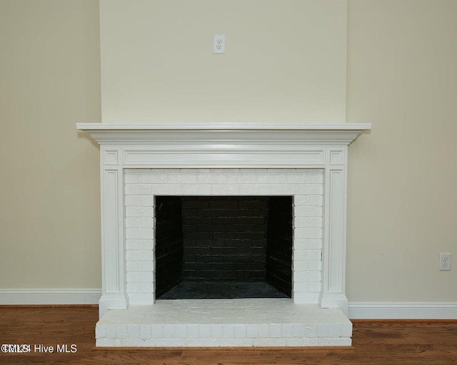 details featuring wood-type flooring and a brick fireplace