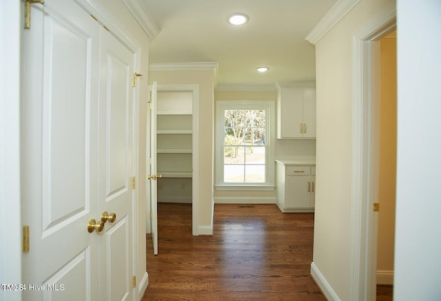 corridor featuring dark hardwood / wood-style floors and crown molding