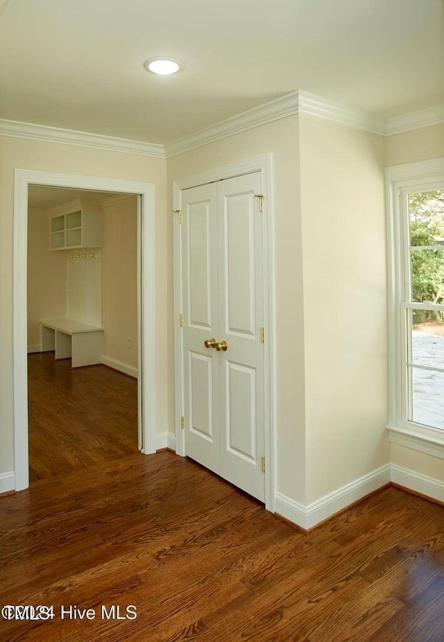 hall with dark hardwood / wood-style flooring and ornamental molding