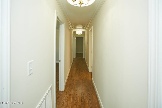 hallway with crown molding and hardwood / wood-style flooring