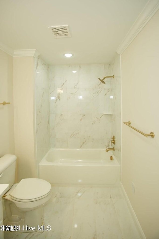 bathroom with tiled shower / bath combo, toilet, and ornamental molding