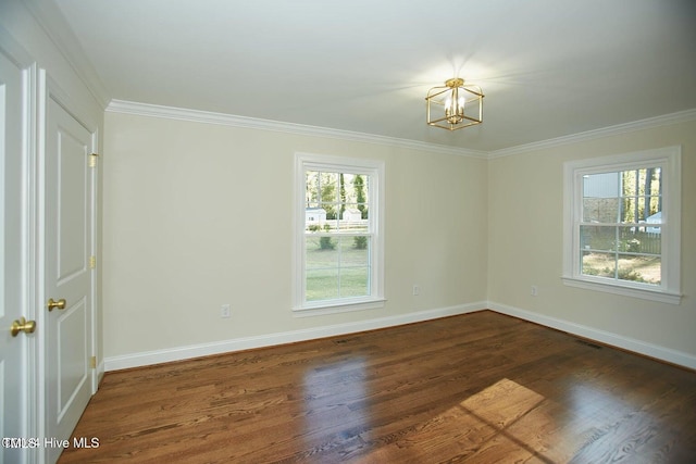 spare room with a notable chandelier, dark hardwood / wood-style floors, and ornamental molding