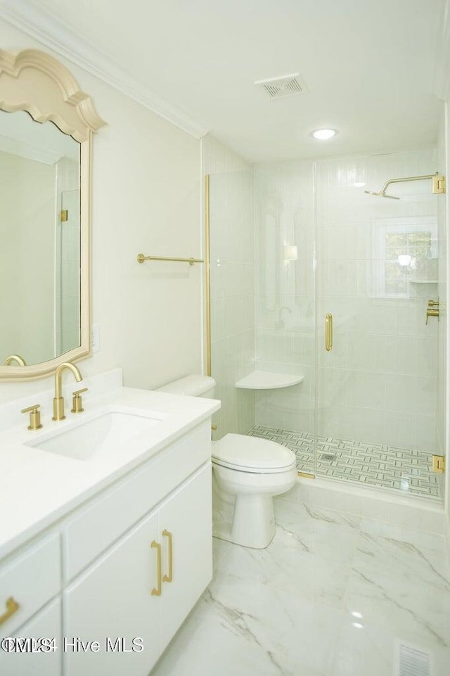 bathroom with a shower with shower door, toilet, ornamental molding, and vanity