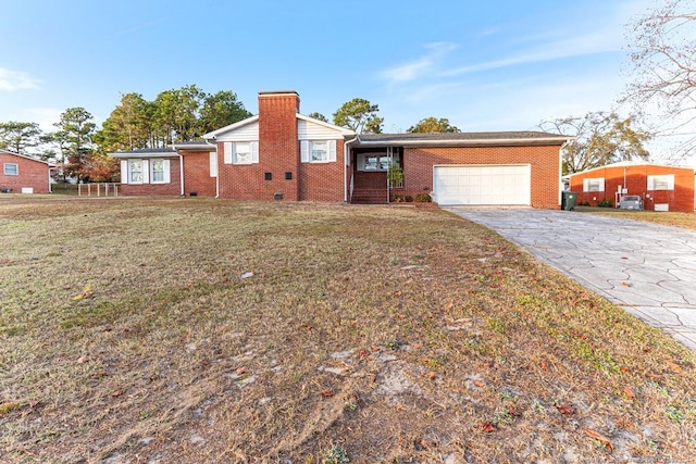 ranch-style home with a garage and a front lawn