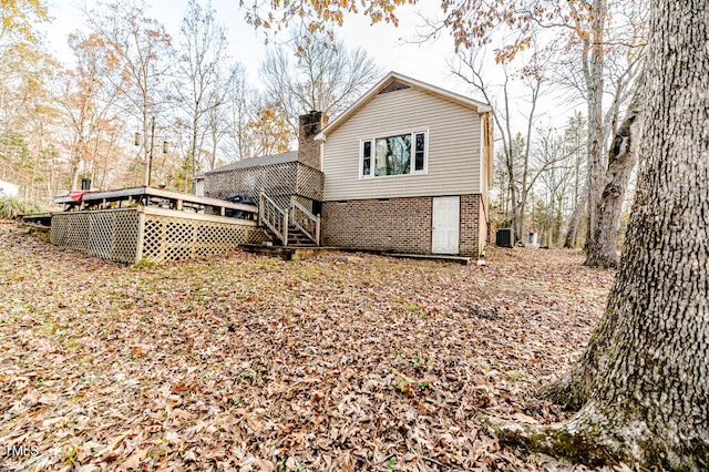 rear view of house featuring a wooden deck