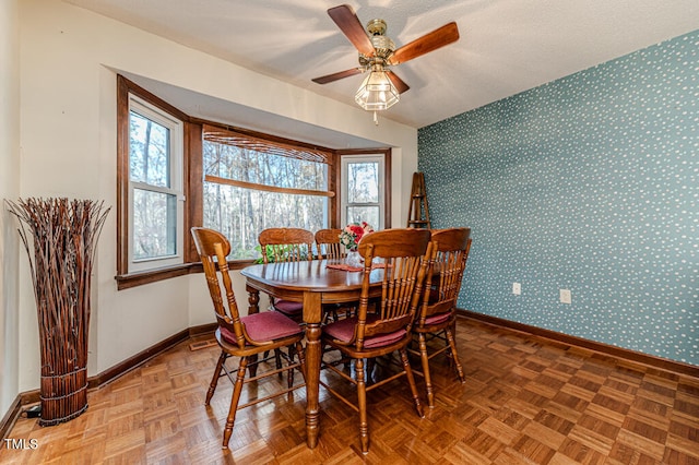 dining room with ceiling fan and parquet floors